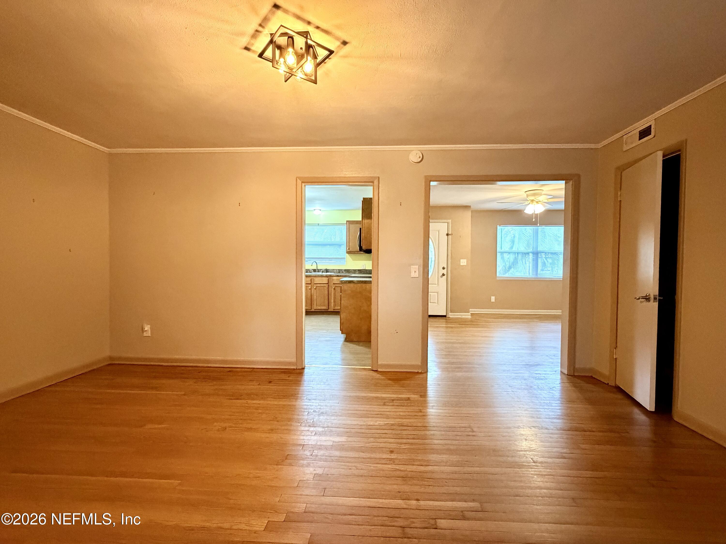 4037 Conga Street Jacksonville, FL 32217 - Photo 7 of 26 a view of a room with wooden floor and a bathroom