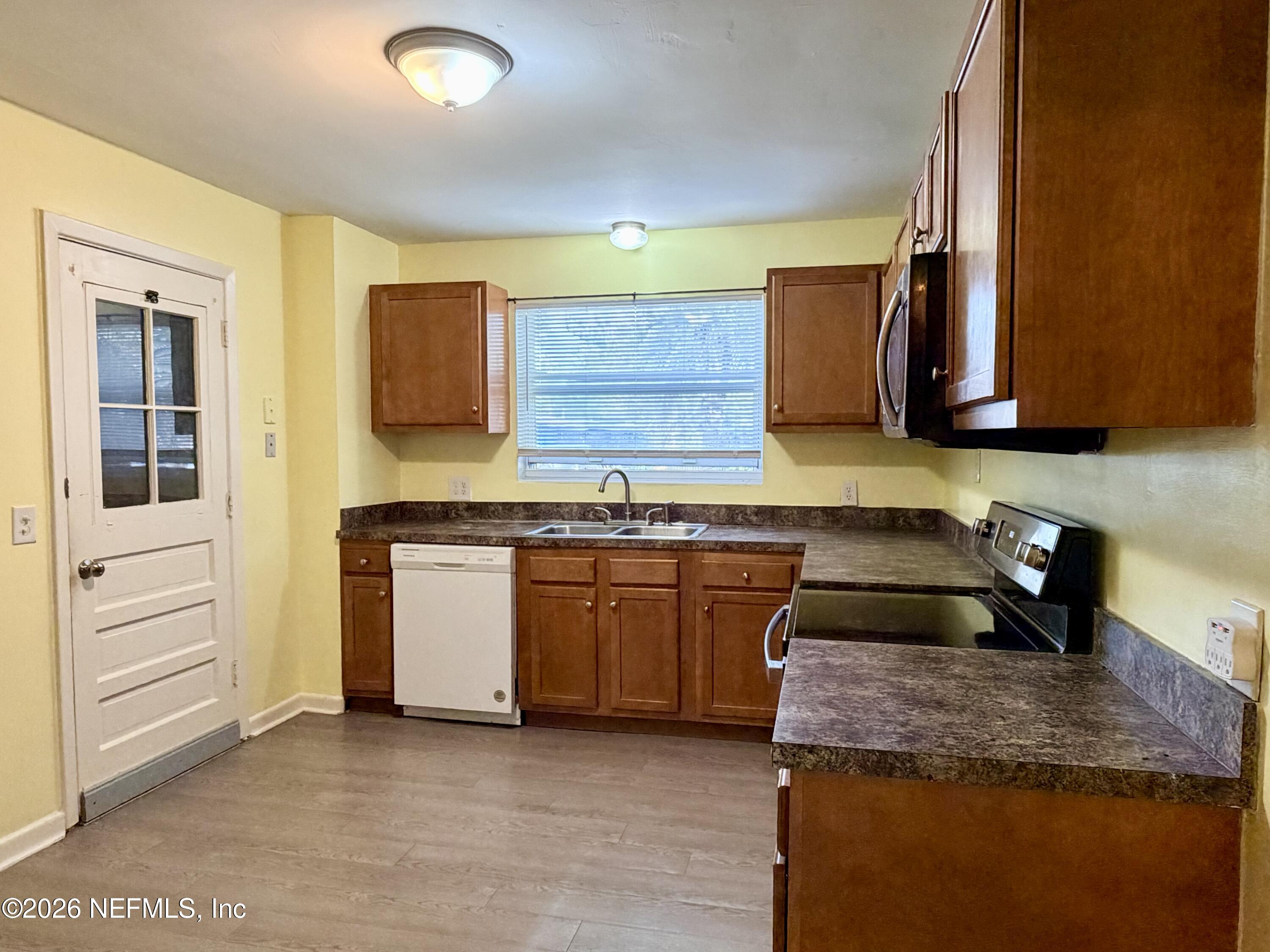 4037 Conga Street Jacksonville, FL 32217 - Photo 10 of 26 a kitchen with granite countertop a sink and a stove top oven