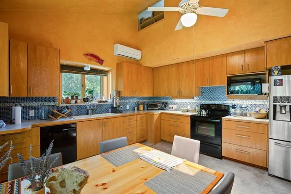 a kitchen with stainless steel appliances granite countertop a sink and cabinets