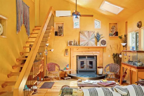 a very nice looking room with wooden floor and furniture