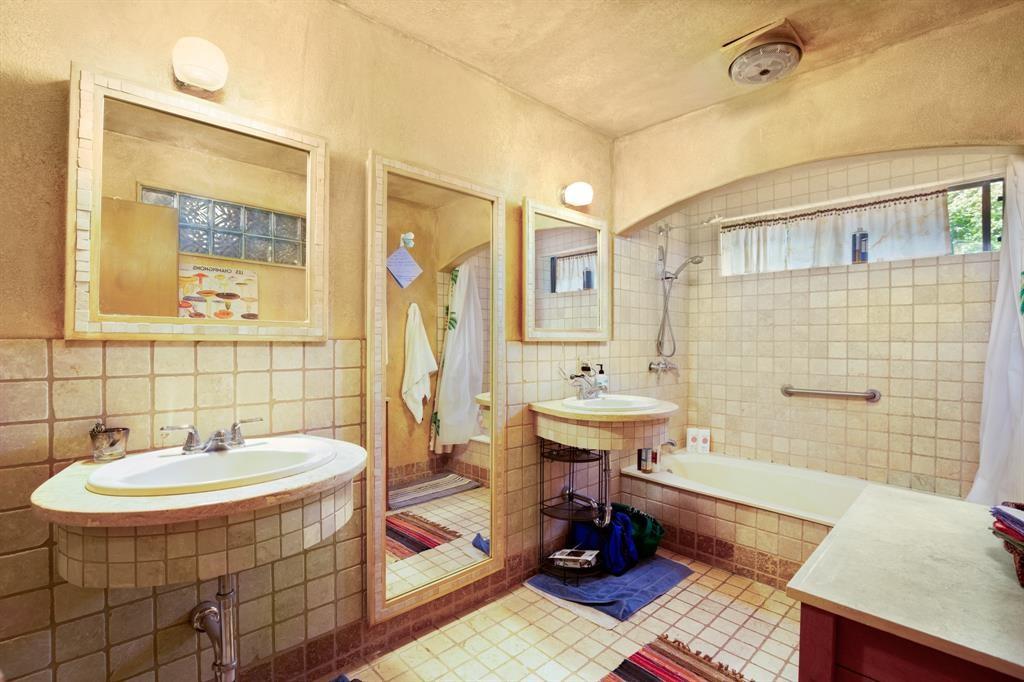 5803 Rittenhouse Shore Drive Austin, TX 78734 - Photo 29 of 35 a bathroom with a sink a mirror and a bathtub