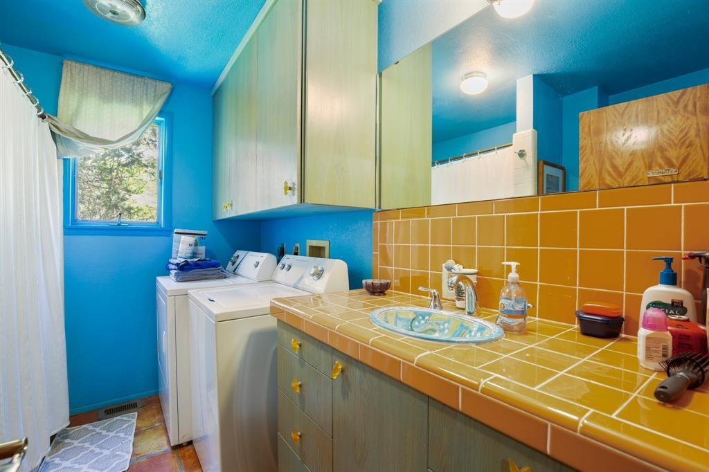 5803 Rittenhouse Shore Drive Austin, TX 78734 - Photo 31 of 35 a bathroom with a sink and a mirror