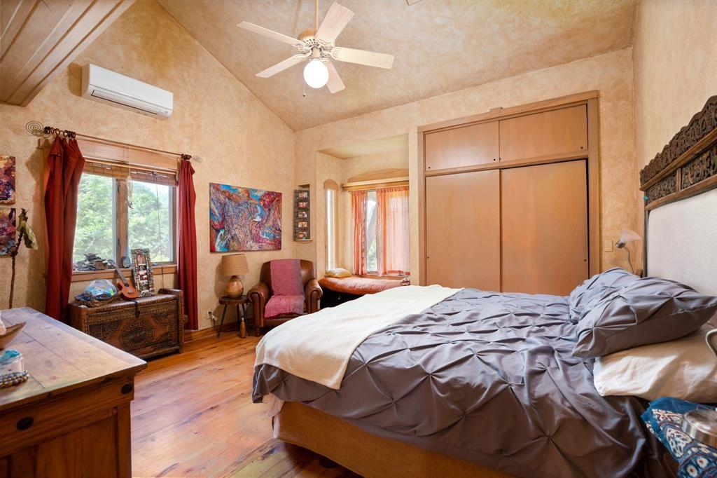 5803 Rittenhouse Shore Drive Austin, TX 78734 - Photo 32 of 35 a bedroom with a bed and wooden floor