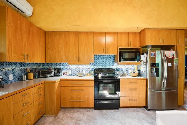 a kitchen with stainless steel appliances a stove a sink and a refrigerator