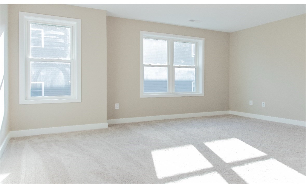52 Richards Street Worcester, MA 01603 - Photo 5 of 20 an empty room with windows