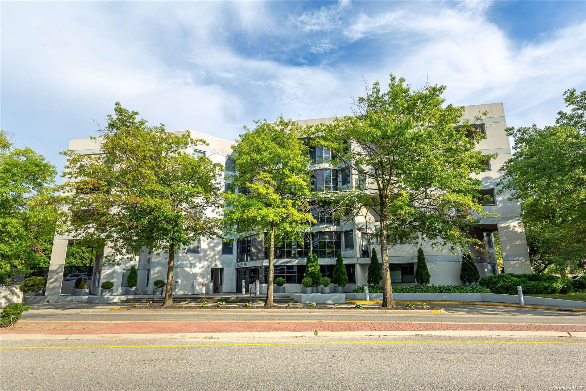 100 Great Neck Road, Unit 1B Great Neck, NY 11021 - Photo 1 of 1 a outdoor view of a building with a garden