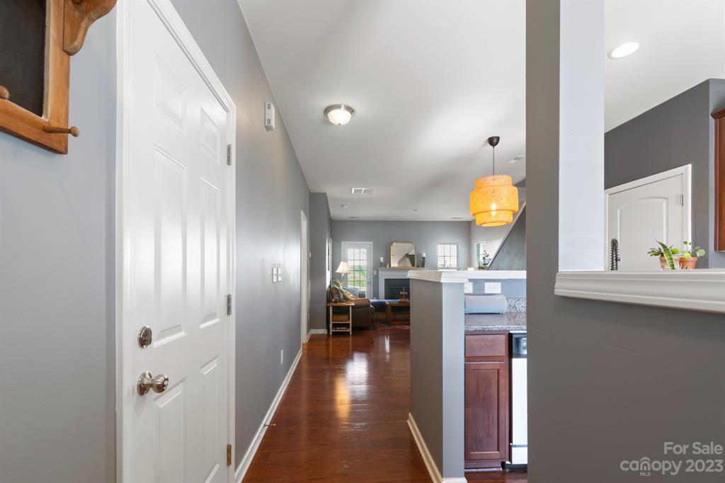 315 Sandy Spring Lane Clover, SC 29710 - Photo 3 of 26 a view of a hallway to a livingroom with wooden floor and furniture
