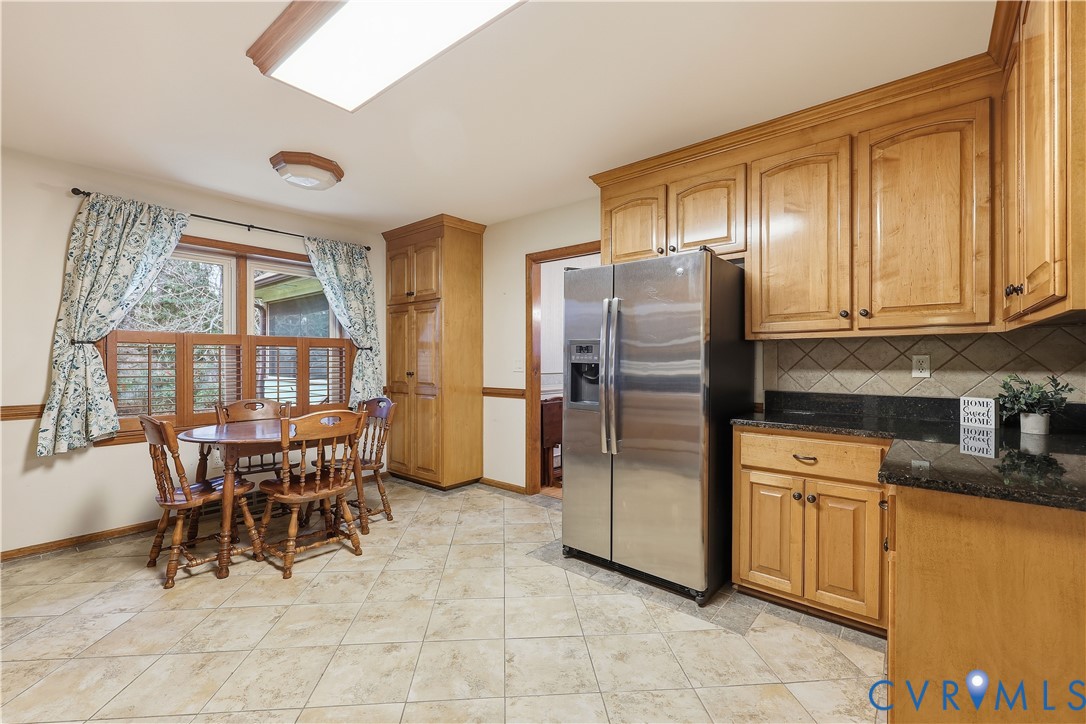 1014 Germar Court Colonial Heights, VA 23834 - Photo 2 of 36 a kitchen with stainless steel appliances granite countertop a refrigerator a stove a dining table and chairs with wooden floor