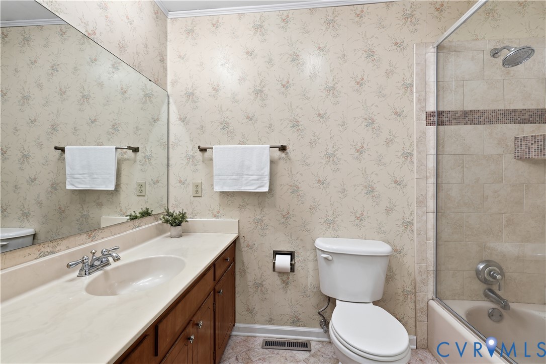 1014 Germar Court Colonial Heights, VA 23834 - Photo 28 of 36 a bathroom with a granite countertop toilet sink and a mirror