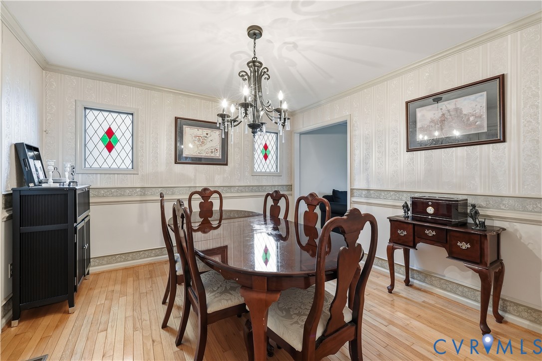 1014 Germar Court Colonial Heights, VA 23834 - Photo 10 of 36 a view of a dining room with furniture wooden floor and a chandelier