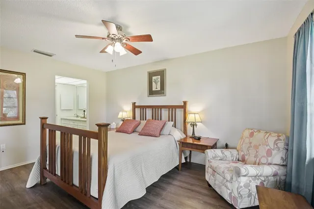 a bedroom with furniture and wooden floor