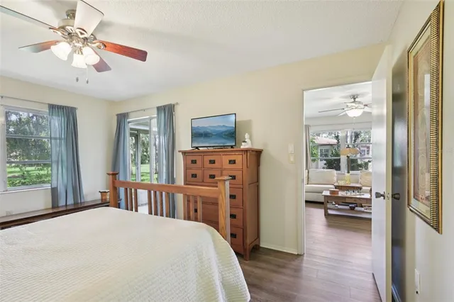 a bedroom with a bed a chandelier and a window