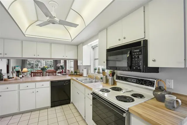 a kitchen with a sink a stove and cabinets