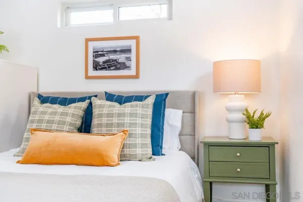 a bedroom with a bed and lamp