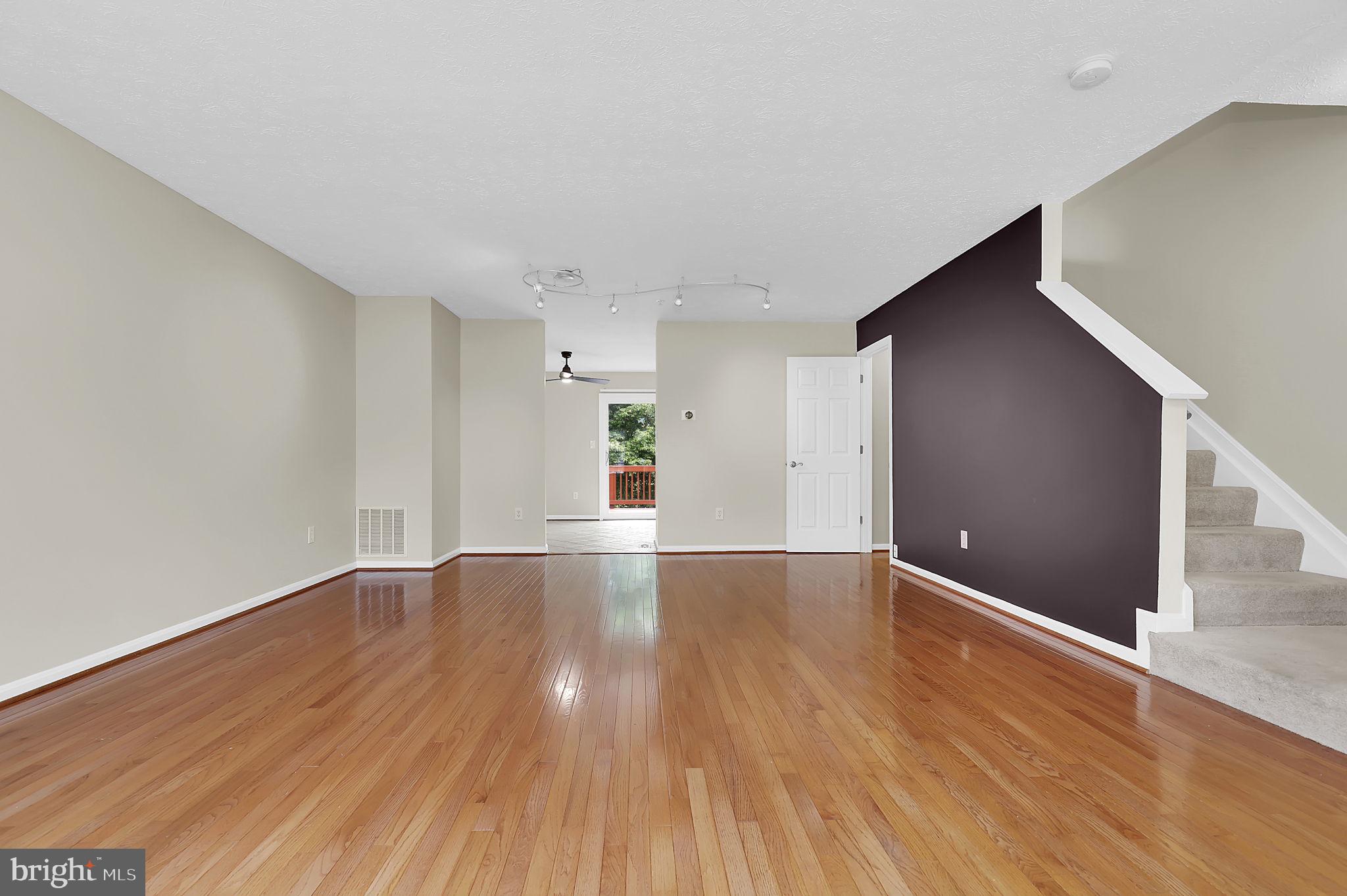 7150 Natures Road Columbia, MD 21046 - Photo 6 of 45 a view of an empty room with wooden floor and a window