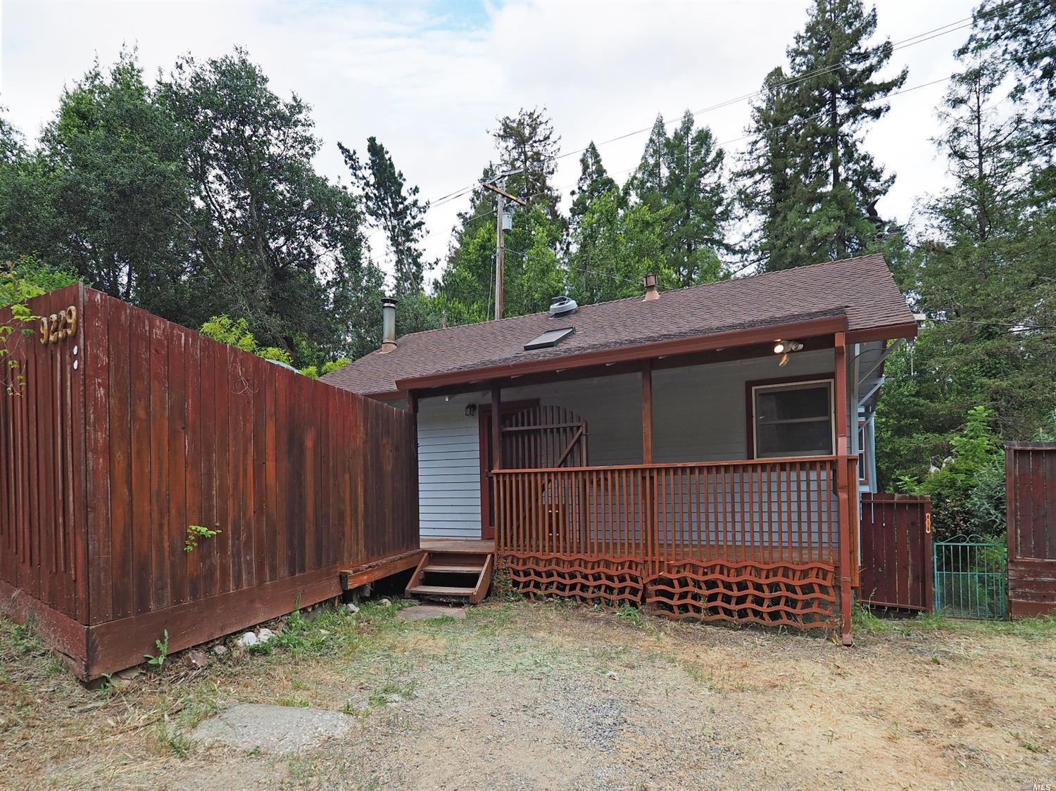9229 Rio Vista Road Forestville, CA 95436 - Photo 1 of 1 a view of a house with a small yard and wooden fence