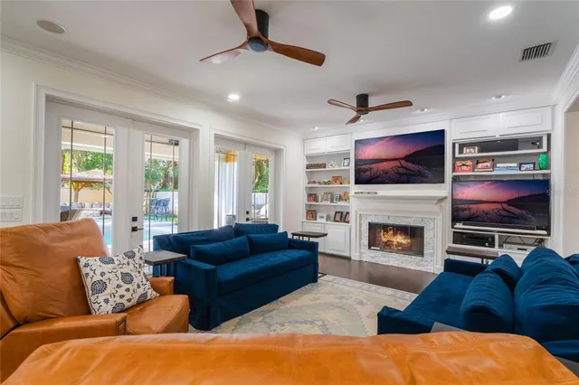 a living room with furniture a flat screen tv and a table