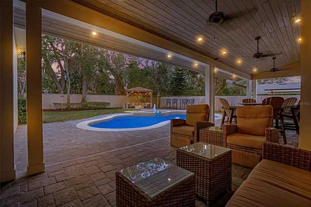 a large white kitchen with lots of counter space a sink dining table and chairs