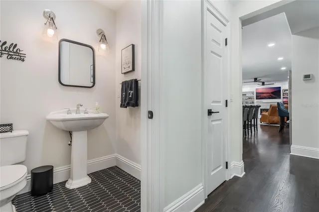 a view of a yard in front of a brick house with a large windows