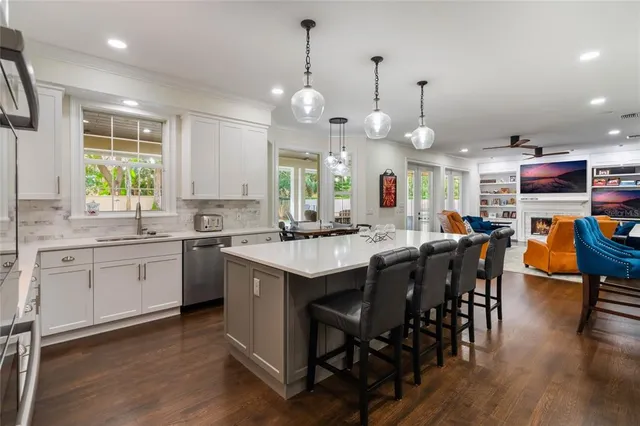a kitchen with stainless steel appliances a refrigerator and a stove top oven