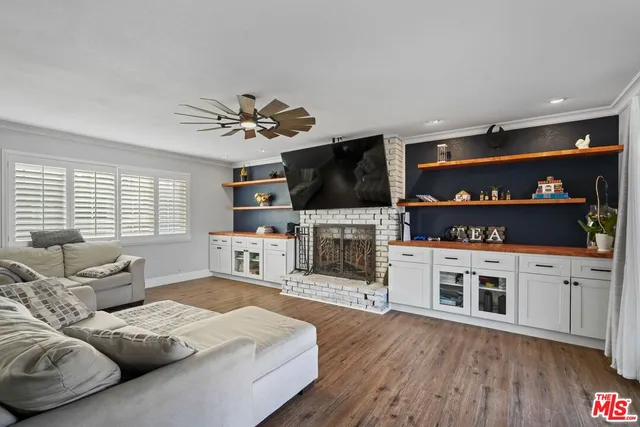 a kitchen with granite countertop a sink cabinets stainless steel appliances and a counter top space