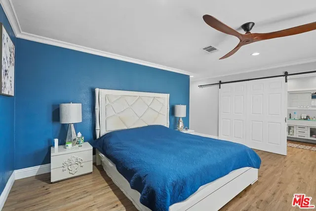 a kitchen with stainless steel appliances a stove and wooden floor