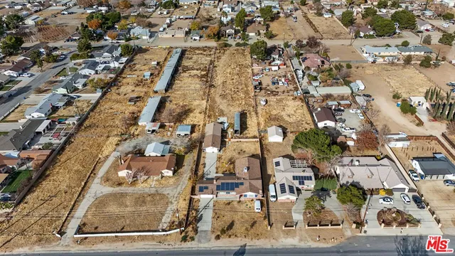 an aerial view of residential house with parking and mountain view