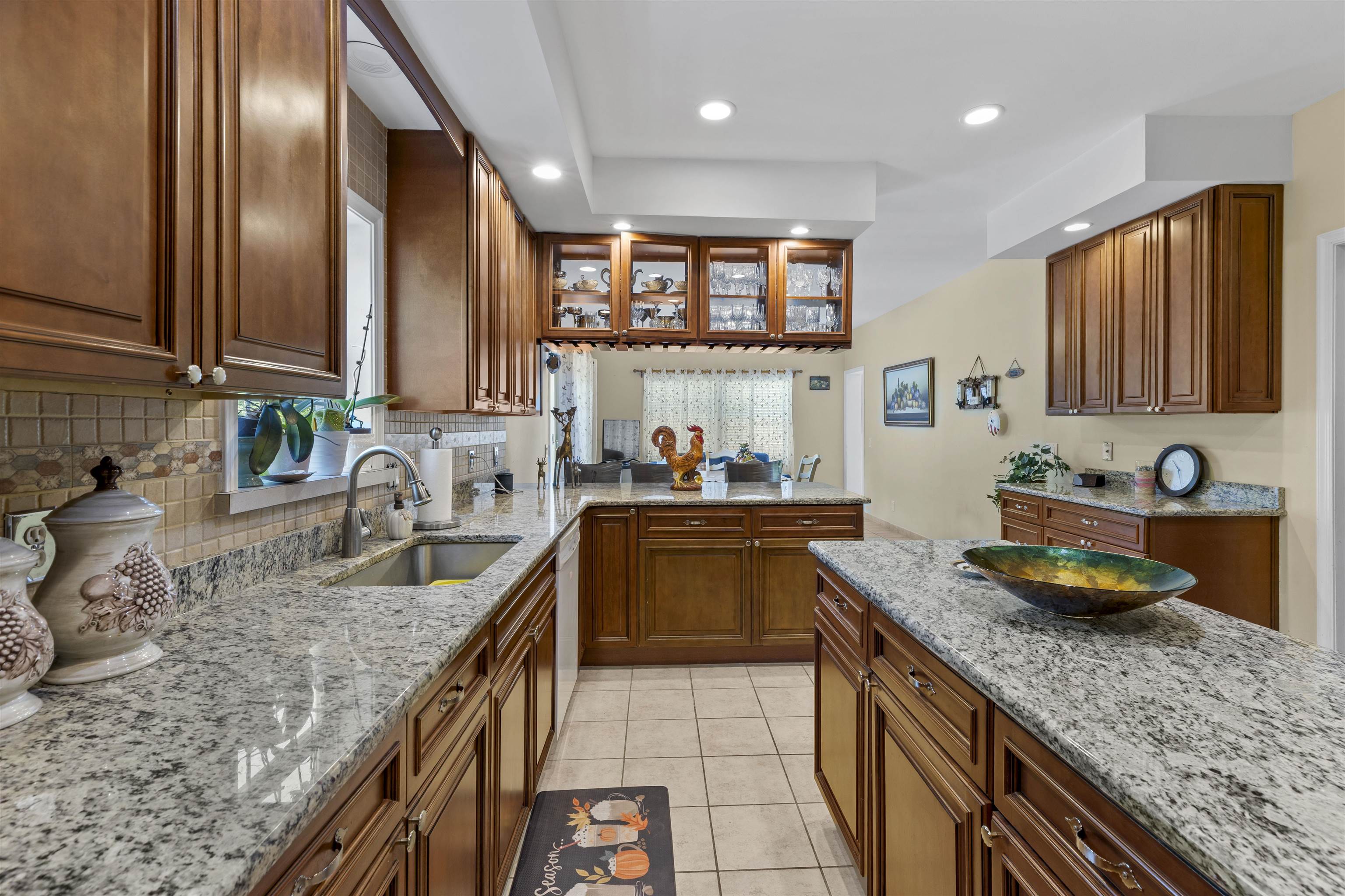 551 Shunpike Road Cape May Court House, NJ 08210 - Photo 7 of 47 a kitchen with stainless steel appliances granite countertop a sink stove and cabinets