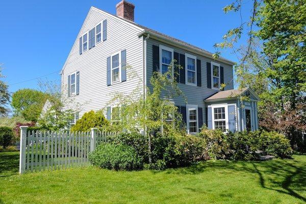4084 Main Street Barnstable, MA 02675 - Photo 1 of 15 a front view of a house with a garden