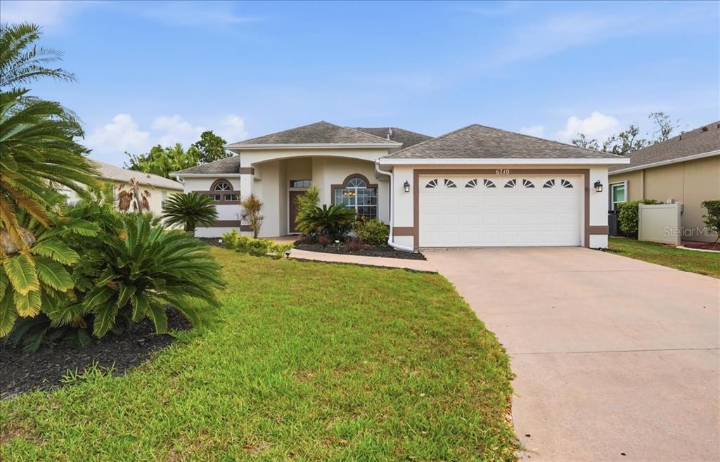 6710 Pleasant Hill Road Bradenton, FL 34203 - Photo 1 of 72 a front view of a house with a yard and garage