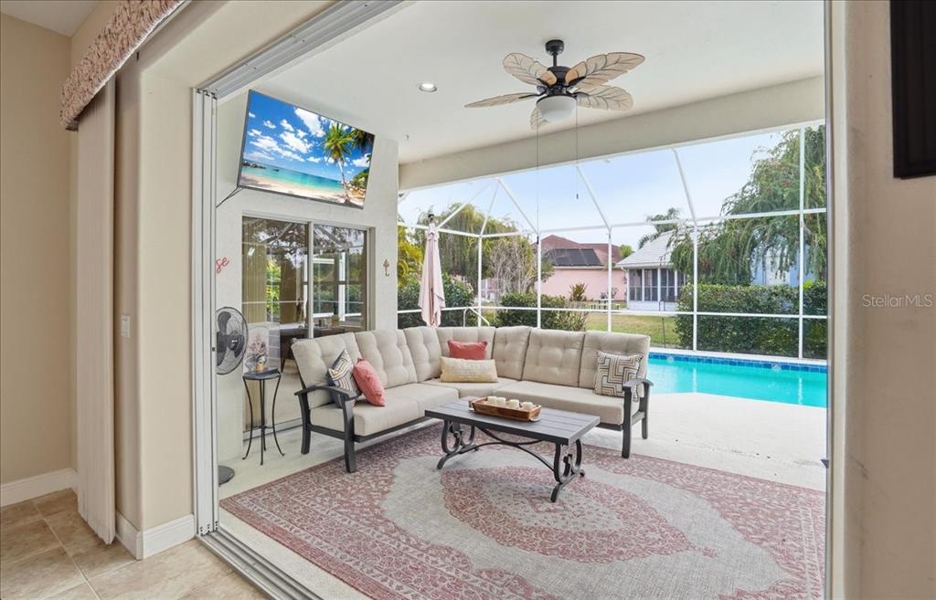 6710 Pleasant Hill Road Bradenton, FL 34203 - Photo 25 of 72 a living room with furniture a floor to ceiling window and a flat screen tv