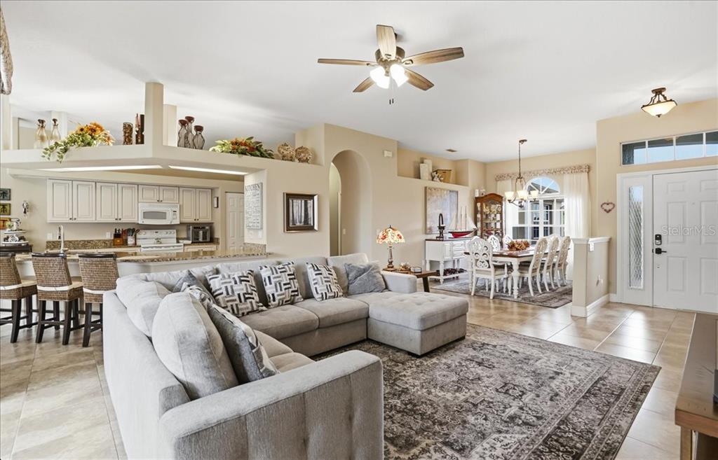 6710 Pleasant Hill Road Bradenton, FL 34203 - Photo 29 of 72 a living room with furniture kitchen view and a chandelier