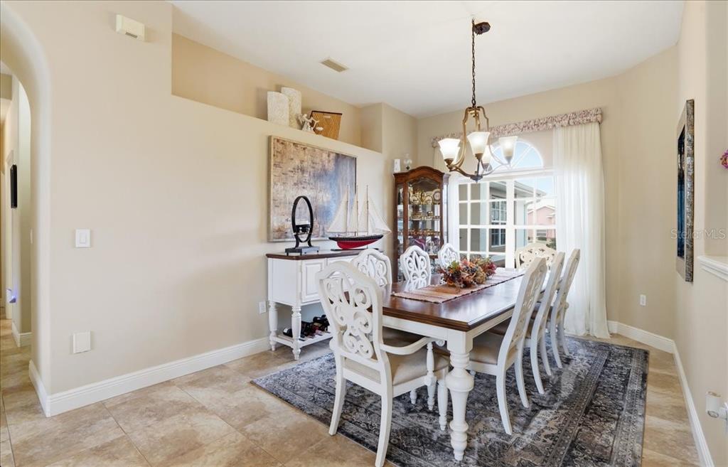 6710 Pleasant Hill Road Bradenton, FL 34203 - Photo 30 of 72 a view of a dining room with furniture and chandelier