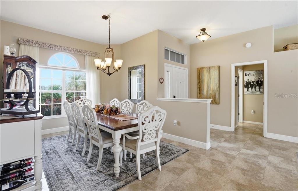 6710 Pleasant Hill Road Bradenton, FL 34203 - Photo 31 of 72 a dining room with furniture a chandelier and window