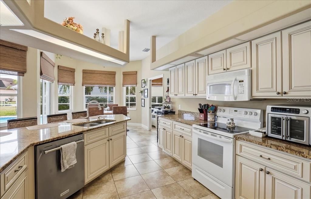6710 Pleasant Hill Road Bradenton, FL 34203 - Photo 34 of 72 a kitchen with stainless steel appliances granite countertop a sink stove and cabinets