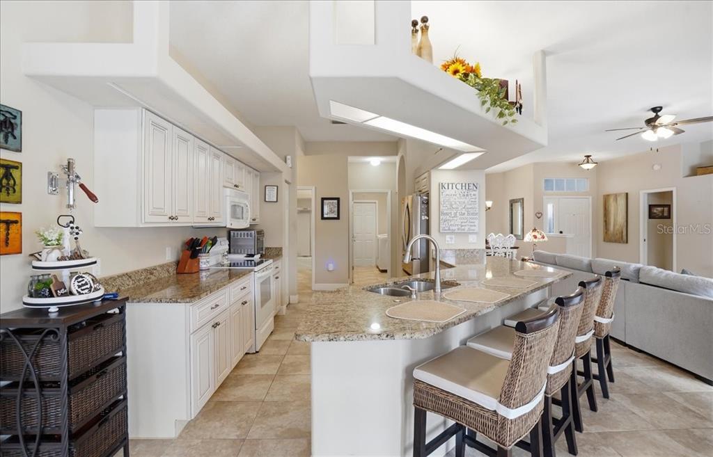 6710 Pleasant Hill Road Bradenton, FL 34203 - Photo 38 of 72 a kitchen with granite countertop a sink and cabinets