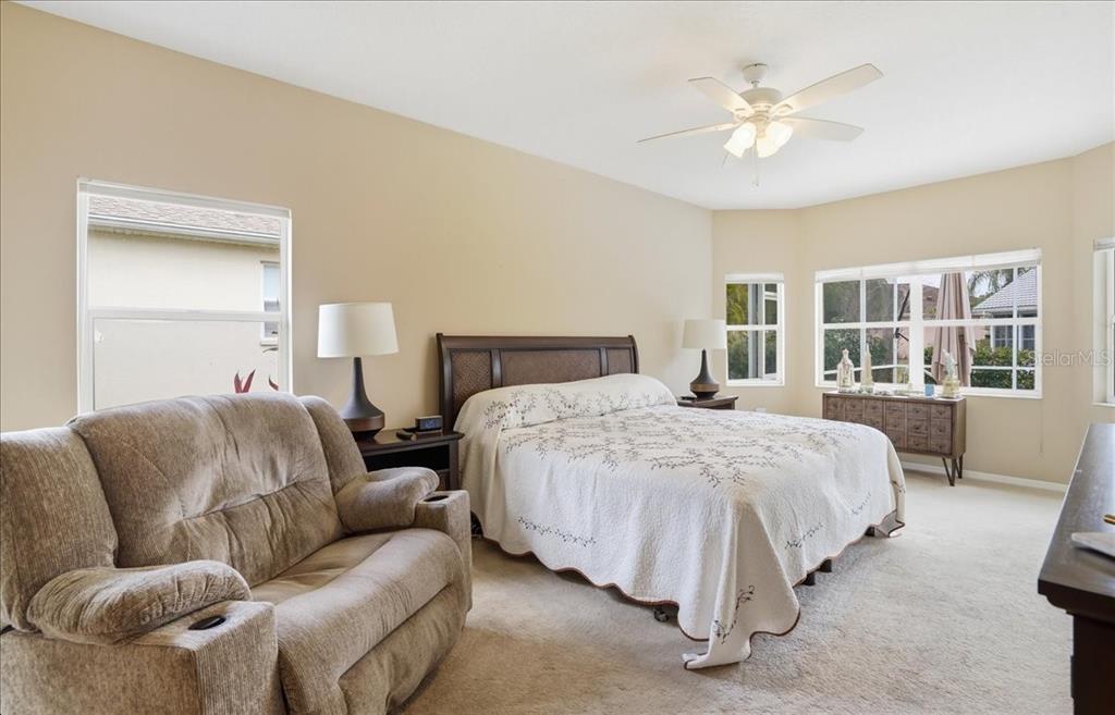 6710 Pleasant Hill Road Bradenton, FL 34203 - Photo 41 of 72 a spacious bedroom with a bed and a couch