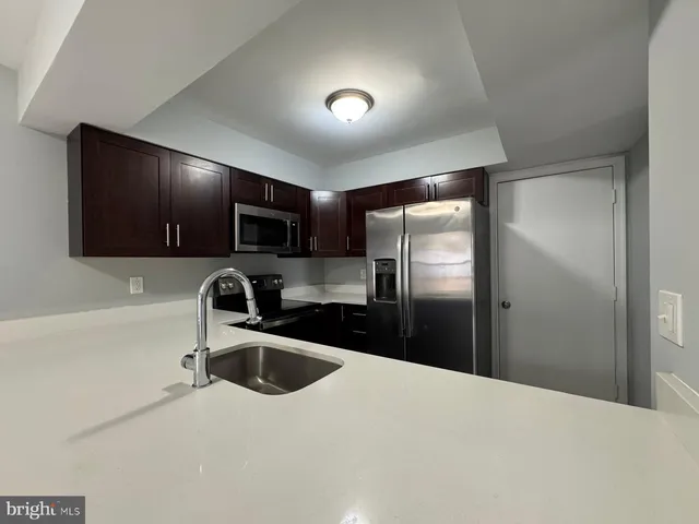 a kitchen with a refrigerator sink and microwave