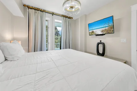 a bedroom with a bed and a flat screen tv