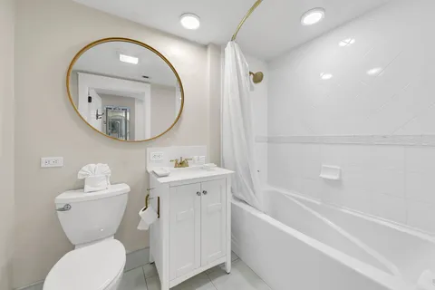 a bathroom with a toilet a sink and a mirror