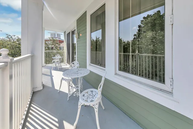 a dining room with furniture and large windows