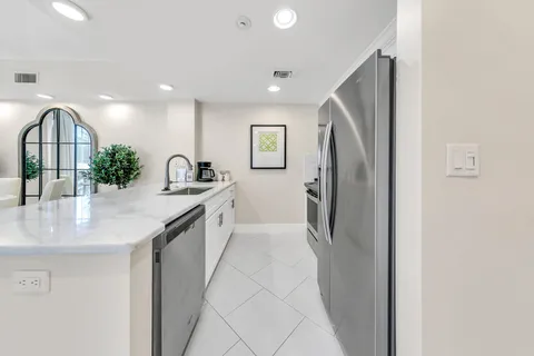 a kitchen with a refrigerator and a sink