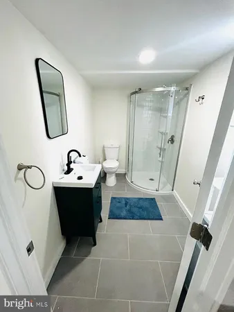 a bathroom with a sink and mirror with bathtub