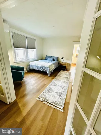 a bedroom with a bed and a couch