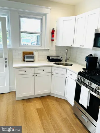 a kitchen with a sink stove and cabinets