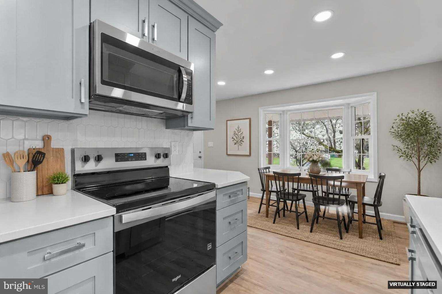 24320 Log House Road Gaithersburg, MD 20882 - Photo 12 of 43 a kitchen with a stove and a microwave