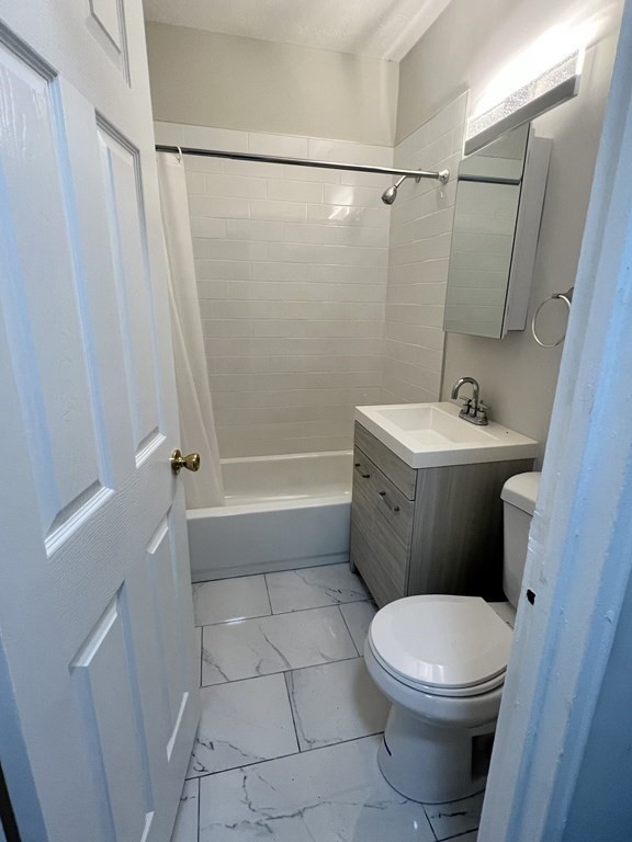 5 Beaver Park Road, Unit 1 Framingham, MA 01702 - Photo 4 of 4 a bathroom with a sink a toilet and shower