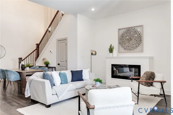 a living room with furniture a fireplace and a potted plant