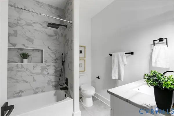 a bath room with a toilet sink and shower
