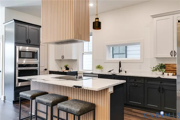 a kitchen with stainless steel appliances a sink and cabinets